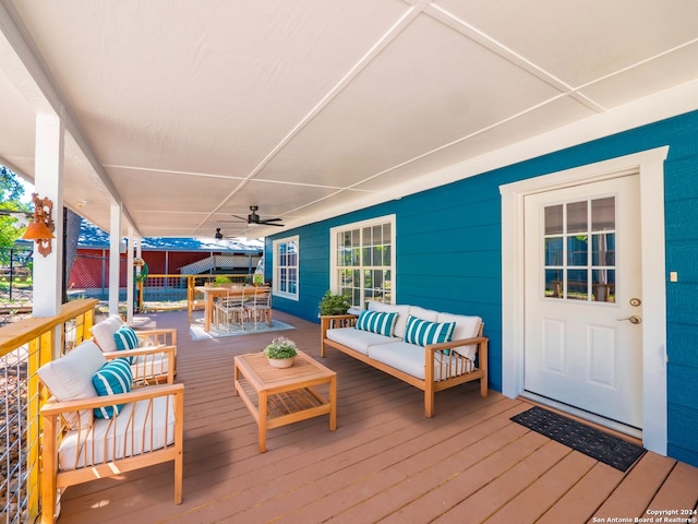 wooden deck with ceiling fan and outdoor lounge area