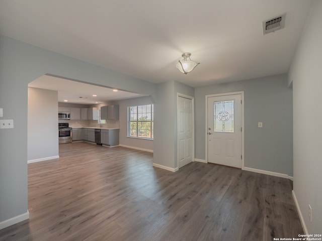 entrance foyer featuring sink and hardwood / wood-style floors