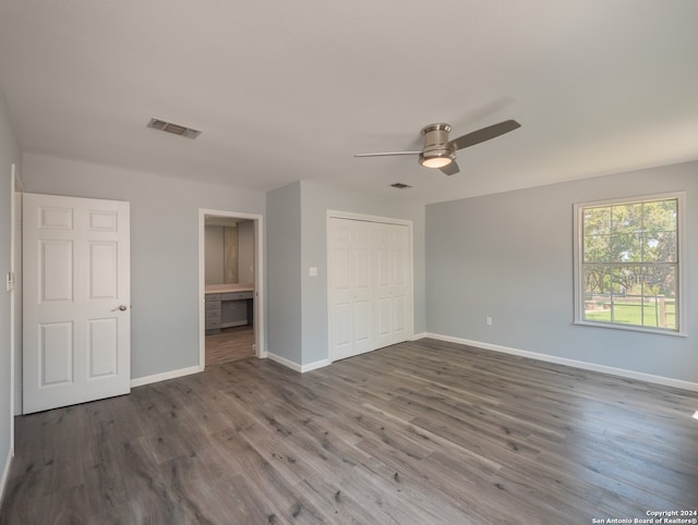 unfurnished bedroom featuring a closet, ceiling fan, and dark hardwood / wood-style floors