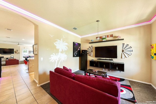 living room with ornamental molding, a textured ceiling, and tile patterned flooring