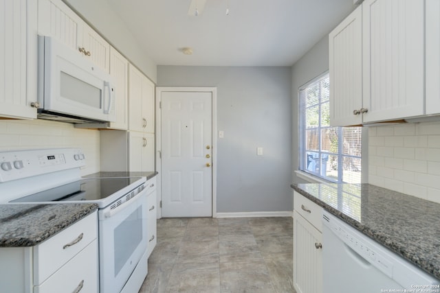 kitchen with backsplash, dark stone counters, white appliances, and white cabinetry