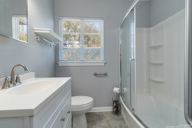 full bathroom featuring tile patterned floors, toilet, combined bath / shower with glass door, and vanity