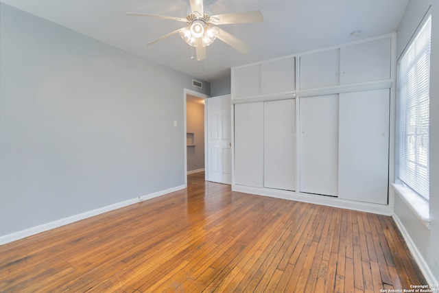 unfurnished bedroom with a closet, ceiling fan, and hardwood / wood-style floors