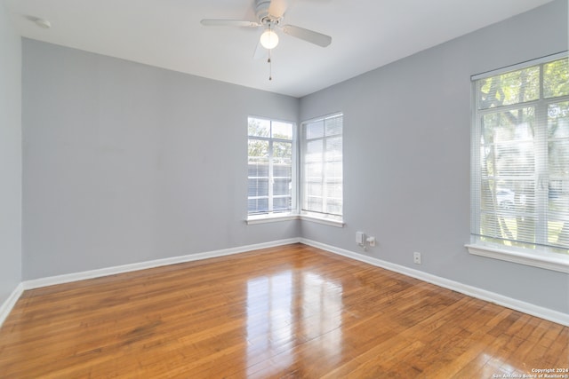 spare room with hardwood / wood-style floors and ceiling fan