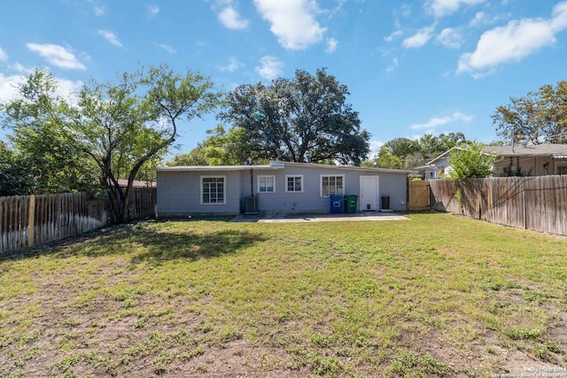 back of property featuring a lawn, central AC, and a patio