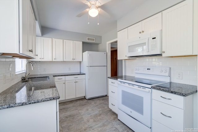 kitchen featuring white appliances, sink, decorative backsplash, white cabinetry, and ceiling fan