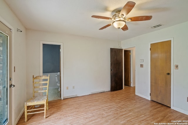 empty room with light hardwood / wood-style flooring and ceiling fan