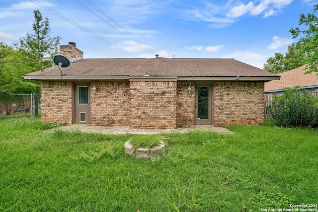 back of property featuring a yard