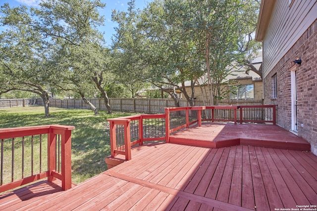 deck featuring a fenced backyard and a yard