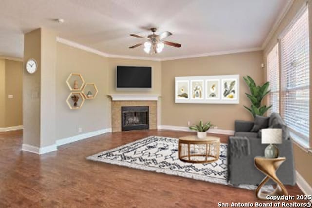 living area featuring wood finished floors, a ceiling fan, baseboards, and ornamental molding