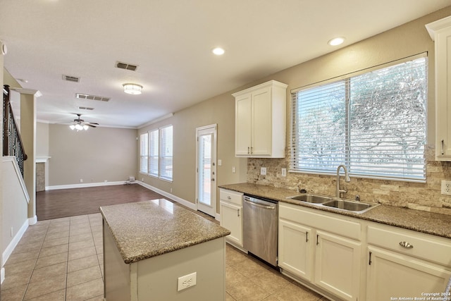 kitchen featuring visible vents, a ceiling fan, stainless steel dishwasher, a sink, and decorative backsplash