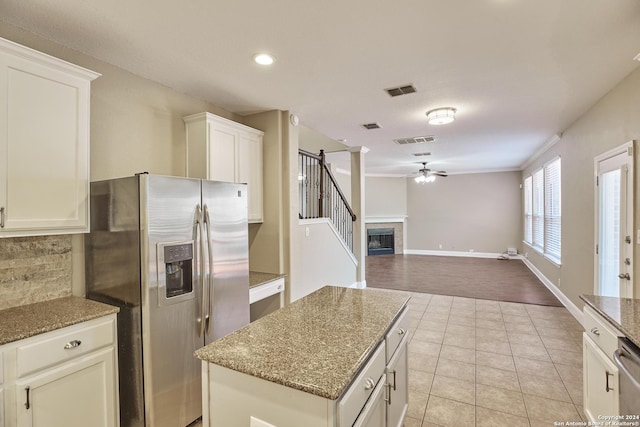 kitchen with visible vents, backsplash, ceiling fan, stainless steel refrigerator with ice dispenser, and light tile patterned floors