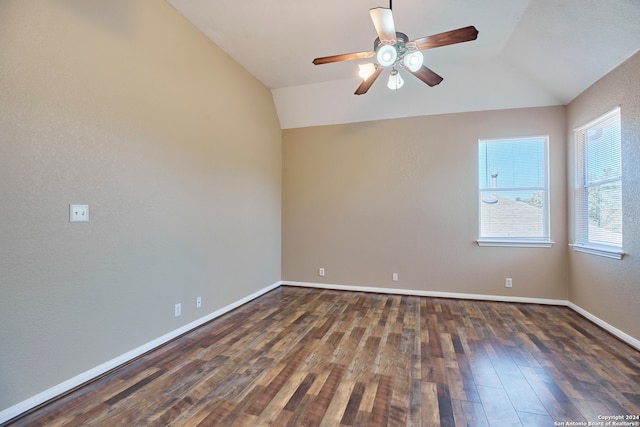 spare room featuring lofted ceiling, dark wood-type flooring, and ceiling fan