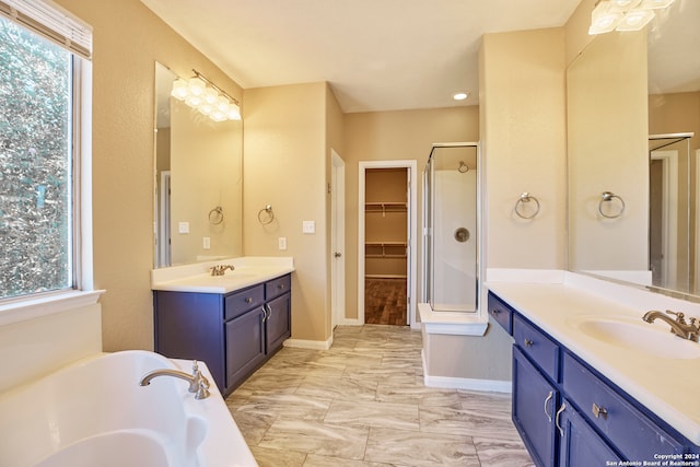 bathroom featuring independent shower and bath and vanity