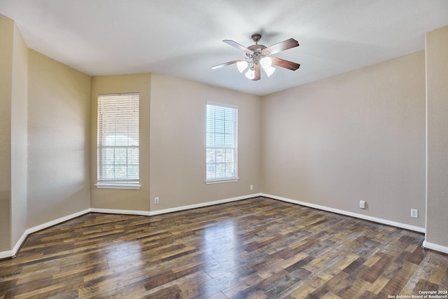 unfurnished room with plenty of natural light, wood finished floors, baseboards, and ceiling fan