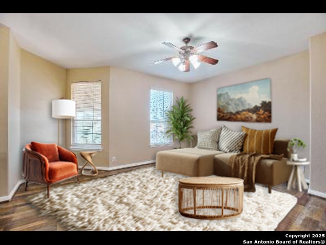 sitting room featuring ceiling fan, baseboards, and wood finished floors