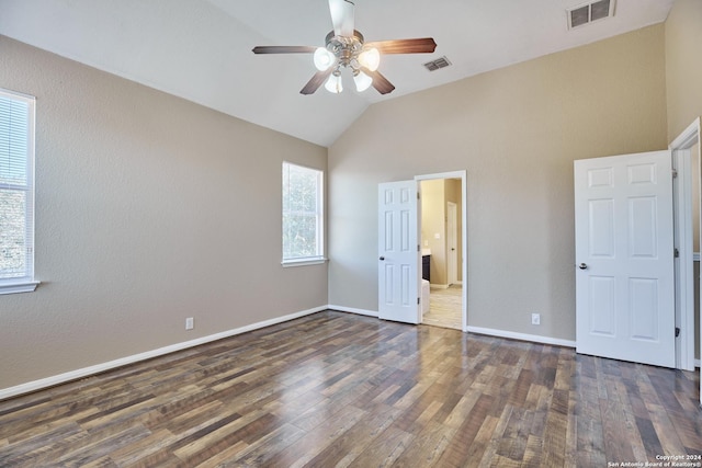 unfurnished bedroom featuring lofted ceiling, wood finished floors, and visible vents