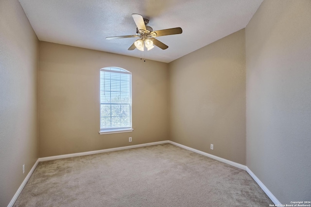 empty room with ceiling fan, baseboards, and carpet flooring