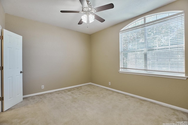 unfurnished room with light carpet, baseboards, and ceiling fan