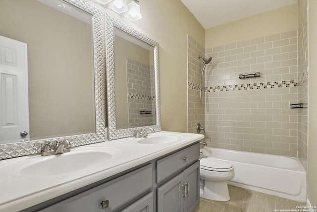 full bathroom with vanity, toilet, and tiled shower / bath