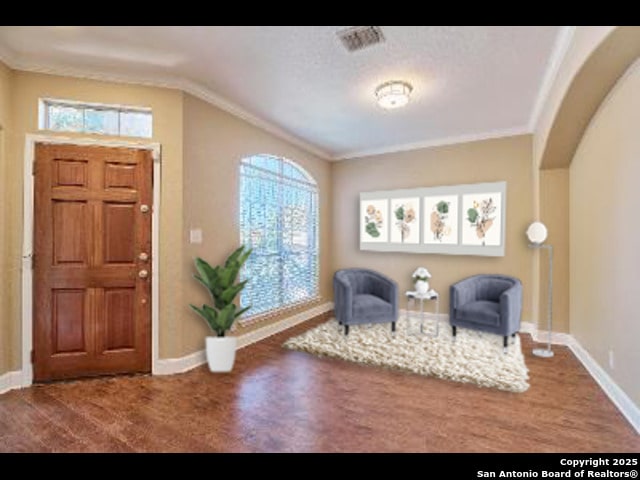 foyer with wood finished floors, baseboards, and a wealth of natural light