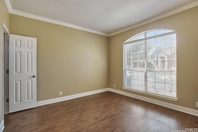 unfurnished room with dark wood-type flooring, crown molding, and baseboards