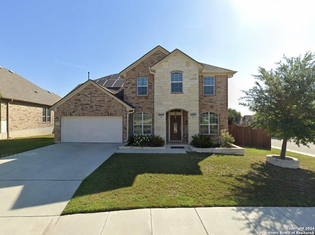 view of front of home with a garage and a front yard