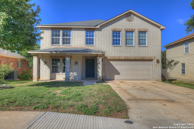 view of front of home featuring a garage, a front yard, cooling unit, and covered porch