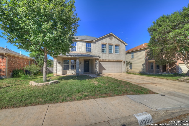 view of front facade featuring a front lawn and a garage