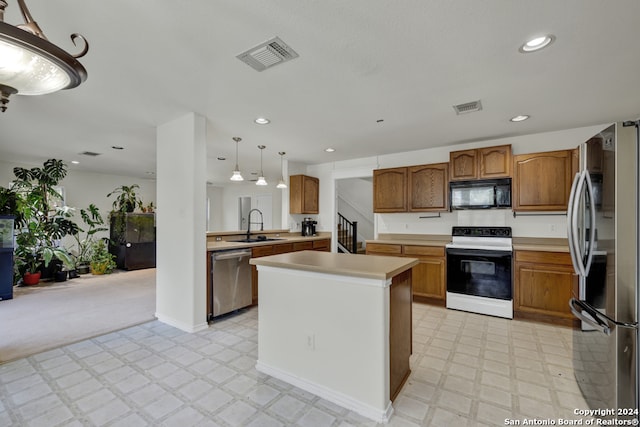 kitchen featuring decorative light fixtures, light carpet, stainless steel appliances, sink, and kitchen peninsula