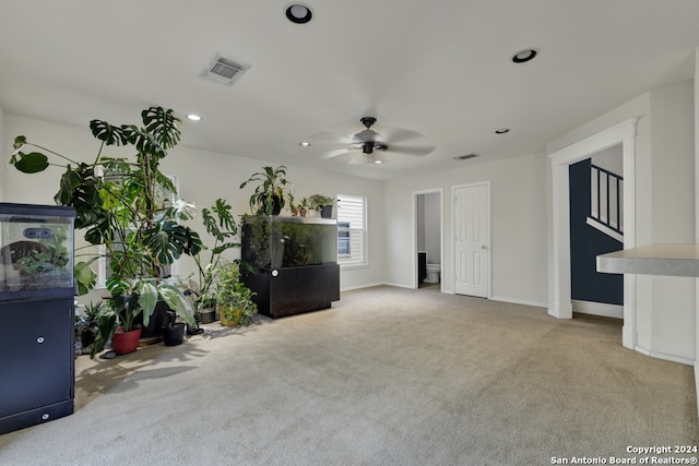 unfurnished living room with ceiling fan and light colored carpet