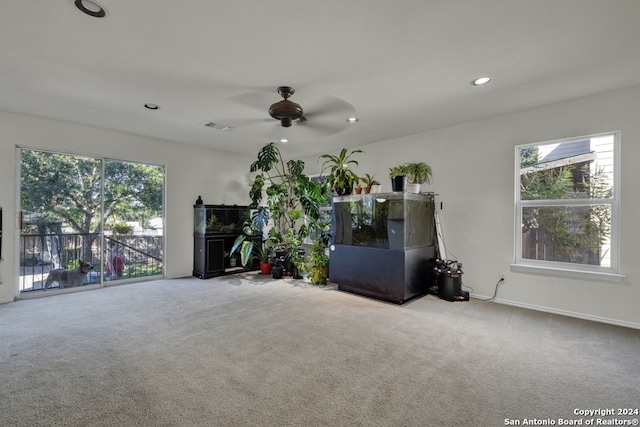 unfurnished living room with carpet floors and ceiling fan