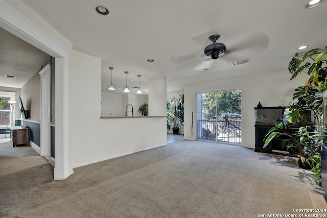 living room with ceiling fan and light colored carpet