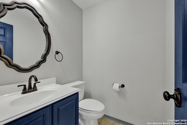 bathroom featuring toilet and vanity