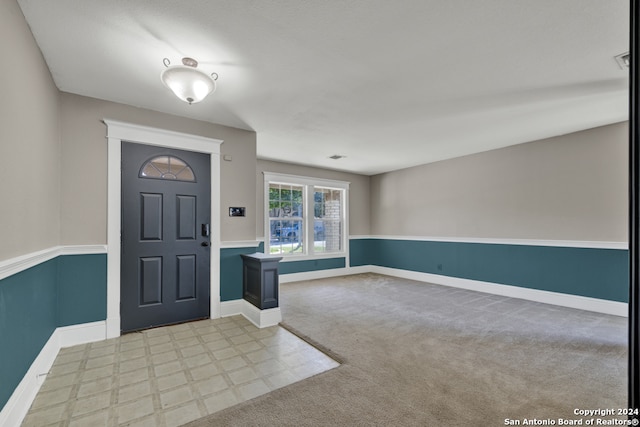 foyer entrance with light carpet