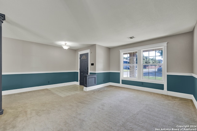 unfurnished room with light colored carpet