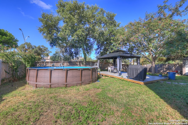 view of yard featuring a gazebo and a fenced in pool