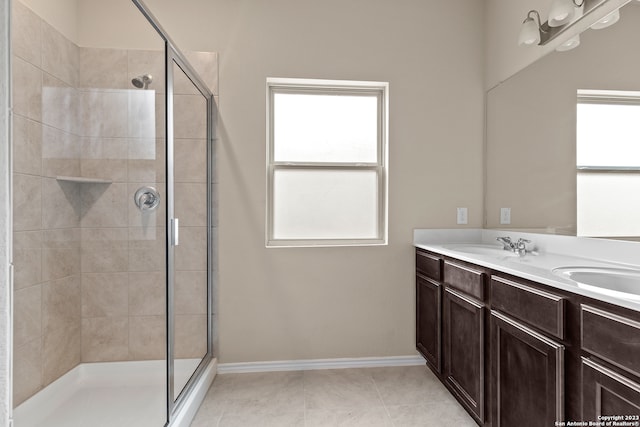 bathroom featuring vanity, an enclosed shower, and tile patterned floors