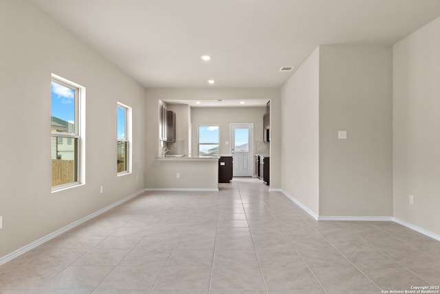 unfurnished living room featuring light tile patterned flooring