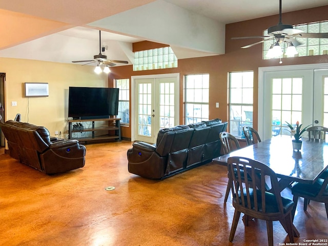 living area featuring plenty of natural light, a ceiling fan, and french doors