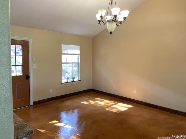 interior space featuring vaulted ceiling, baseboards, and an inviting chandelier