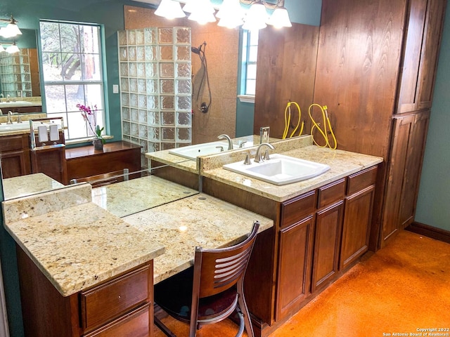 full bath with a wealth of natural light, a sink, and a walk in shower