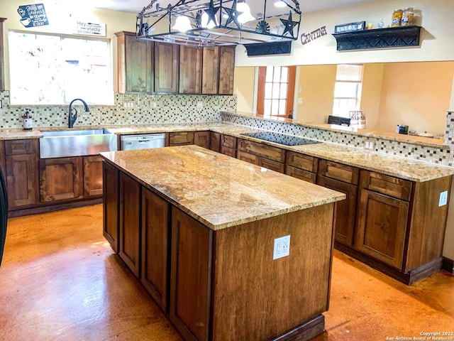 kitchen with backsplash, a sink, concrete flooring, a center island, and black electric stovetop