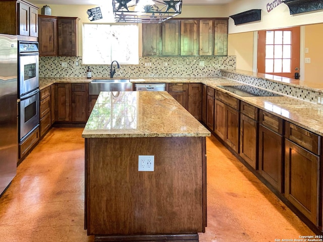 kitchen featuring a center island, a sink, appliances with stainless steel finishes, and tasteful backsplash