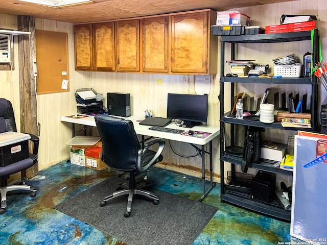 office space with wood walls and concrete floors