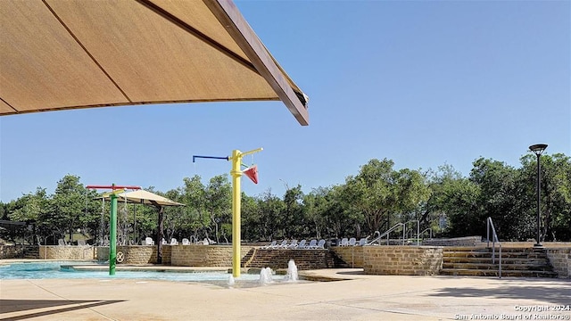 view of sport court with pool water feature