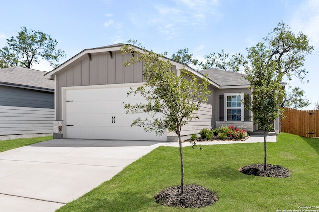 ranch-style home featuring a garage and a front lawn