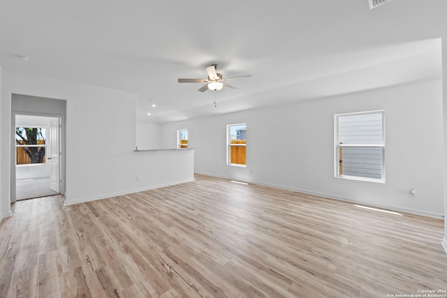 unfurnished living room featuring ceiling fan and light hardwood / wood-style floors