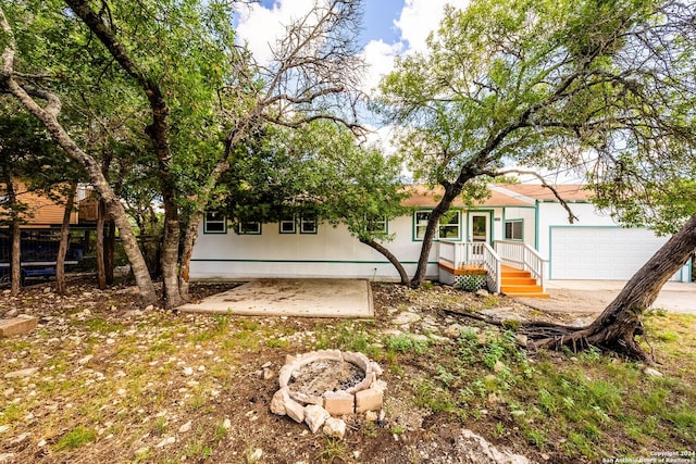 rear view of property with a garage