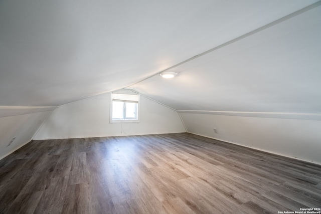 bonus room with lofted ceiling and wood-type flooring